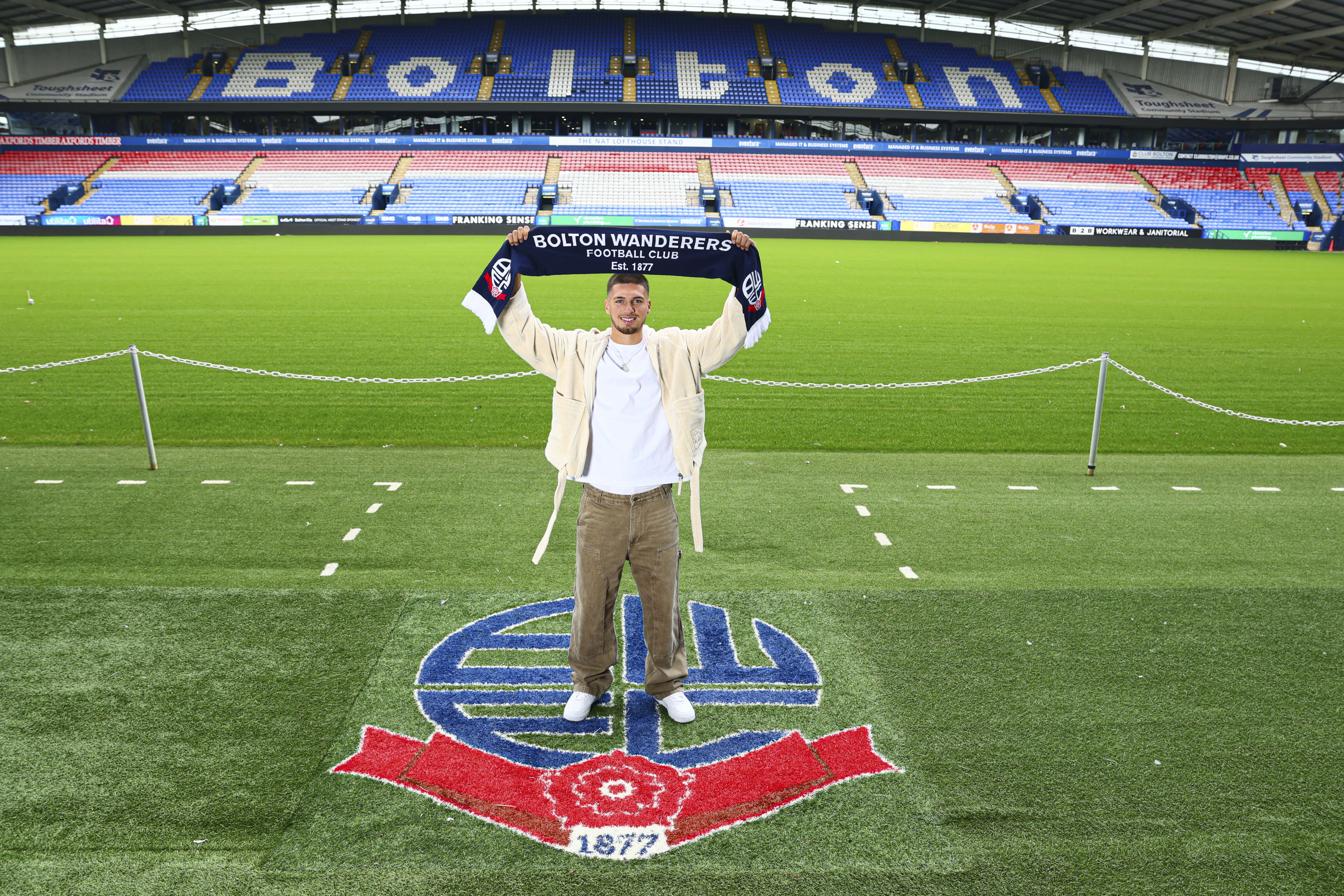 Xavier Simons holding a scarf at the Toughsheet