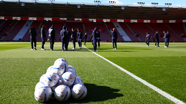 Bolton Wanderers players stand on St.Mary's pitch