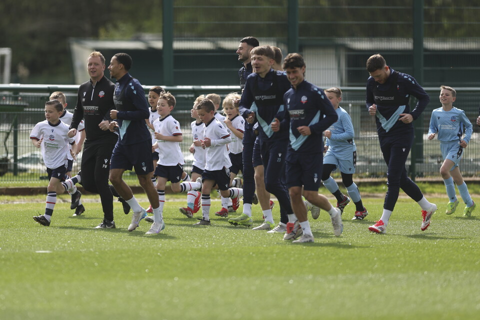 Under 8s warming up with players