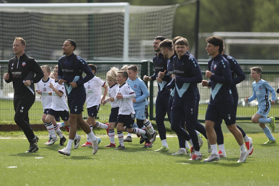 Under 8s warming up with players