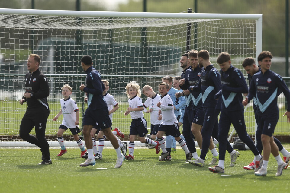 Under 8s warming up with players