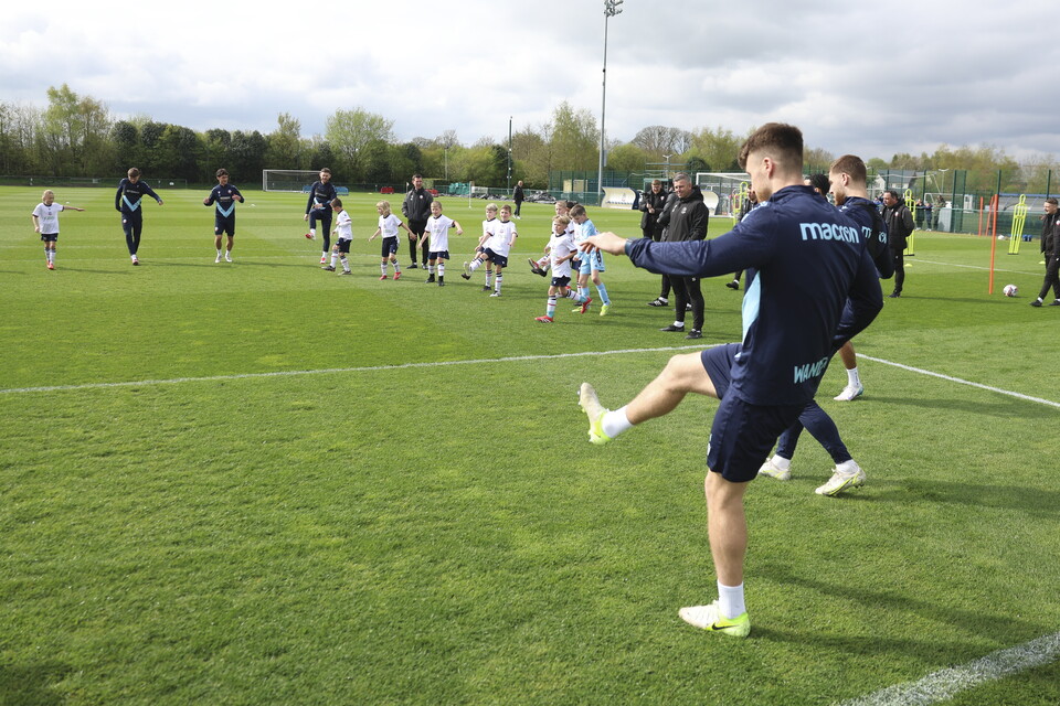 Under 8s warming up with several players