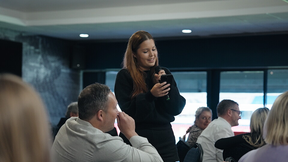 Businesswoman speaking during Business Club event